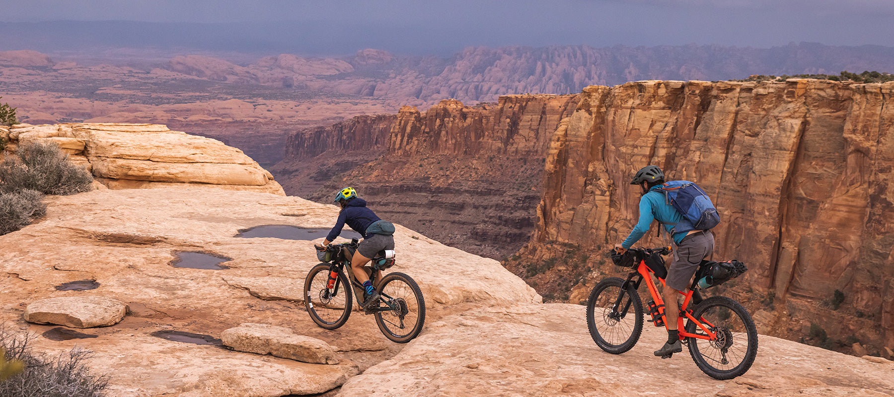 Two mountain bikers riding on canyon rim