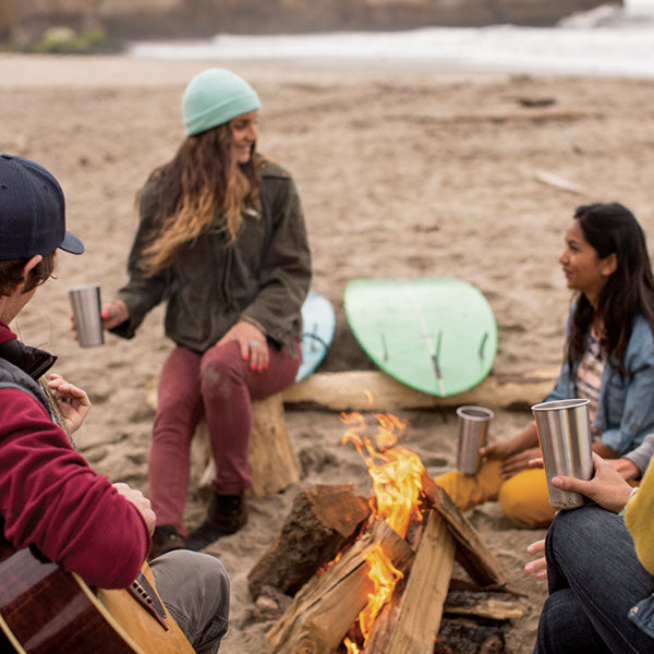 Beach bonfire party with steel pints